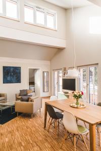 a dining room and living room with a table and chairs at Maison Bellevue in Westendorf
