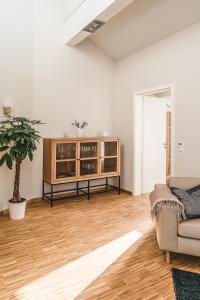 a living room with a couch and a cabinet at Maison Bellevue in Westendorf
