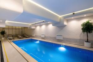 a large swimming pool in a hotel room at Renion Almaty Hotel in Almaty