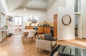 a kitchen and living room with a table and a couch at Maison Bellevue in Westendorf