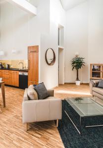 a living room with a couch and a glass table at Maison Bellevue in Westendorf +19 photos