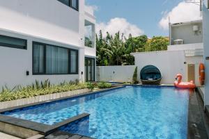 an image of a swimming pool in a house at Domu Alba Vita in Denpasar