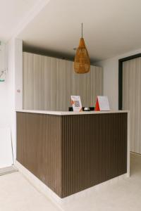 a lobby with a reception desk and a pendant at Domu Alba Vita in Denpasar +64 photos