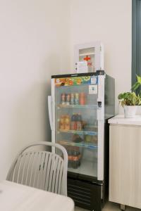 an open refrigerator with food inside of it at Domu Alba Vita in Denpasar