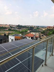 a group of solar panels on top of a roof at BJ Home in Iseri-Oke
