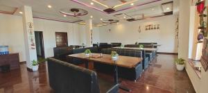 a restaurant with tables and chairs in a room at RUDRAKSH HOTEL & RESTAURANT in Kumbhalgarh in Kumbhalgarh
