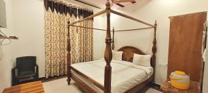 a bedroom with a four poster bed in a room at RUDRAKSH HOTEL & RESTAURANT in Kumbhalgarh in Kumbhalgarh +65 photos