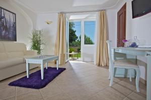 a living room with a couch and a table at Hotel Villa Ceselle in Anacapri