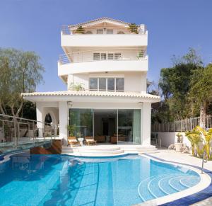a house with a swimming pool in front of a house at Villa Stefani with Private Pool in Athens +60 photos