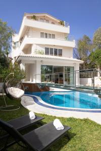 a building with a swimming pool in front of a house at Villa Stefani with Private Pool in Athens