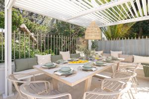 a dining table and chairs on a patio at Villa Stefani with Private Pool in Athens
