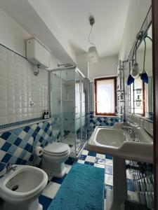 a bathroom with a toilet and a sink and a tub at Ketty's House in Vico Equense +14 photos