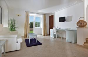 a living room with a white couch and a table at Hotel Villa Ceselle in Anacapri