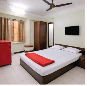 a bedroom with a large bed with a red blanket at Hotel amrit in Indore