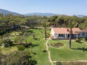 an aerial view of a garden with palm trees and a house at Villa Eura in Pula +7 photos