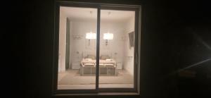 a room with a bed through a glass door at Villa Eura in Pula
