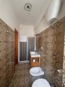 a bathroom with two toilets and a sink and a shower at MONOLOCALI DA VINCI in Falconara Marittima +49 photos