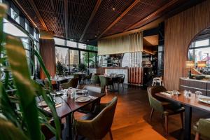 a restaurant with wooden floors and tables and chairs at Souk Al Bahar - Burj Khalifa - Dream View Holiday Home Rental in Dubai