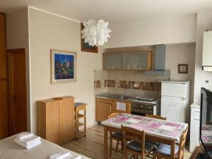 a kitchen with a table and a dining room at MONOLOCALI DA VINCI in Falconara Marittima