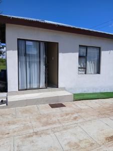 a white house with a bench in front of it at Efkay Guest in Thohoyandou