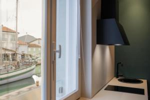 a lamp sitting on a counter next to a window at Le Stanze Di Vittoria in Cesenatico
