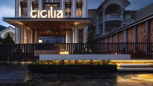 a building with a sign on the side of it at CICILIA Rouge Dalat in Da Lat
