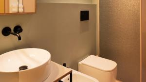 a bathroom with a sink and a toilet at Le Stanze Di Vittoria in Cesenatico +14 photos