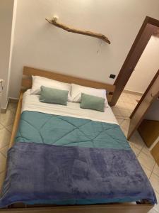 a bed with two pillows on it in a room at House A73 in Lezzeno