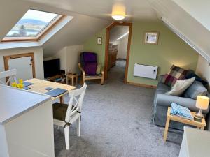 a living room with a table and a couch at Skye Getaways Self Catering Accommodation in Dunvegan