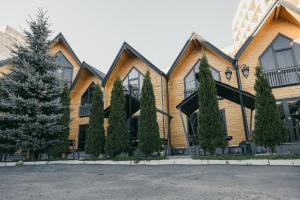 a wooden house with trees in front of it at Everest Rest House in Tsaghkadzor
