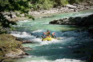 a group of people on a raft in a river at Rafting Camp Palfau in Palfau