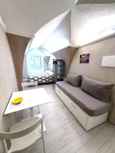 a room with a couch and a table and a bed at Casapà in Atrani