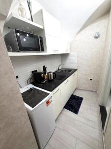 a small kitchen with a sink and a microwave at Casapà in Atrani +11 photos