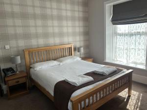 a bedroom with a bed with two pillows on it at Broadway Country House in Laugharne