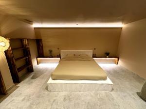 a bedroom with a bed in the middle of a room at ExSPArience Private Spa Suite in Poitiers +2 photos