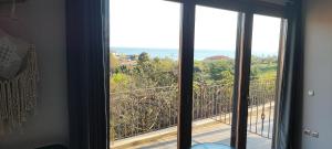 a room with a window with a view of the ocean at Stone house with seaview in Nea Potidaea