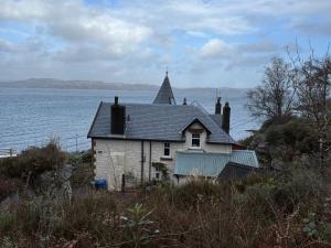 an old house on the shore of the water at Dunivaig B&B in Tarbert +27 photos