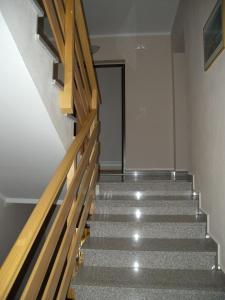 a staircase in a building with wooden railings at Apartment Liznjan 2 in Ližnjan