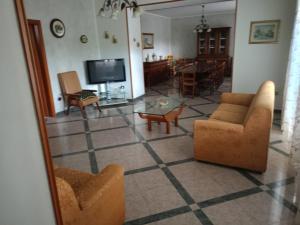 a living room with two couches and a tv at Masseria Sant' Anna in Cerreto Sannita