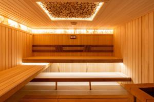 a sauna with a bench in the middle of it at Renion Almaty Hotel in Almaty