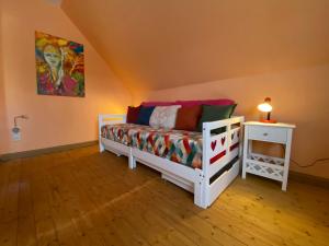 a bedroom with a bed and a table with a lamp at Ferienhaus Soonwald in Schwarzerden