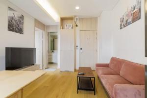 a living room with a couch and a flat screen tv at Siamese Residence Sukhumvit 42 Bangkok in Bangkok