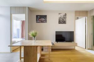 a living room with a table and a tv at Siamese Residence Sukhumvit 42 Bangkok in Bangkok