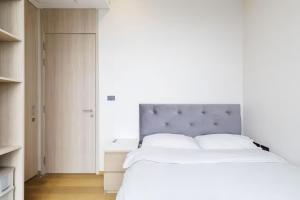 a bedroom with a large white bed with a blue headboard at Siamese Residence Sukhumvit 42 Bangkok in Bangkok +82 photos