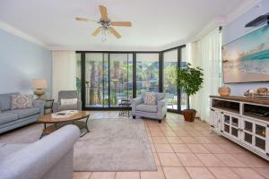 a living room with a couch and a tv at Phoenix on the Bay 1122 condo in Orange Beach +39 photos