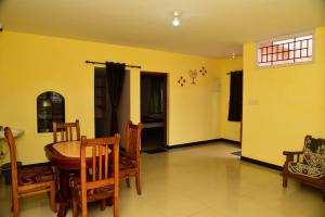 a dining room with a table and chairs at FFF Cottage in Ooty