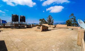an empty parking lot with a skate park and buildings at FFF Cottage in Ooty