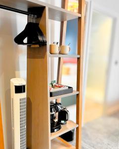 a book shelf with pots and pans on it at Haslar Rooms in Gosport