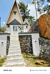 a house with a steep staircase in front of it at Marine waters retreat Block A in Embu