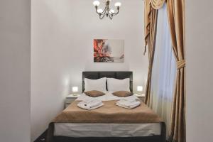 a bedroom with a bed with two towels on it at Hotel Carol - Vatra Dornei in Vatra Dornei